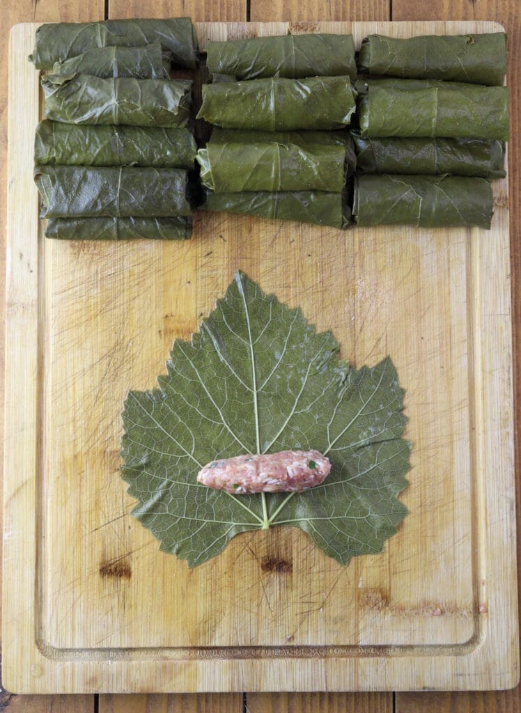 First image of how to stuff grape vine leaves.
